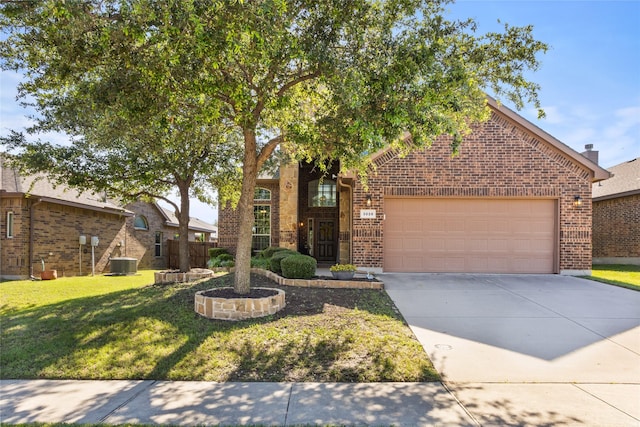 3028 Maple Creek Dr, Fort Worth, TX 76177 - view of front of property featuring brick siding, cooling unit, a garage, driveway, and a front lawn