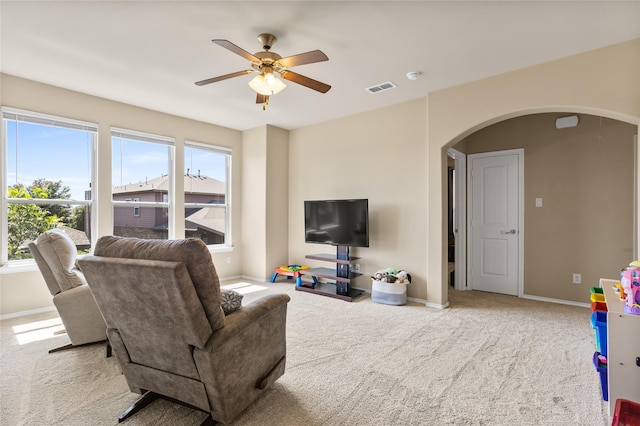 3028 Maple Creek Dr, Fort Worth, TX 76177 - living room featuring arched walkways, ceiling fan, carpet, and baseboards