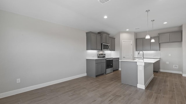 1736 River Bend Rd, Burleson, TX 76028 - kitchen with stainless steel appliances, gray cabinetry, backsplash, dark wood-type flooring, and recessed lighting