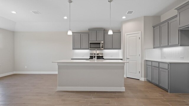 1736 River Bend Rd, Burleson, TX 76028 - kitchen with appliances with stainless steel finishes, gray cabinets, baseboards, and recessed lighting