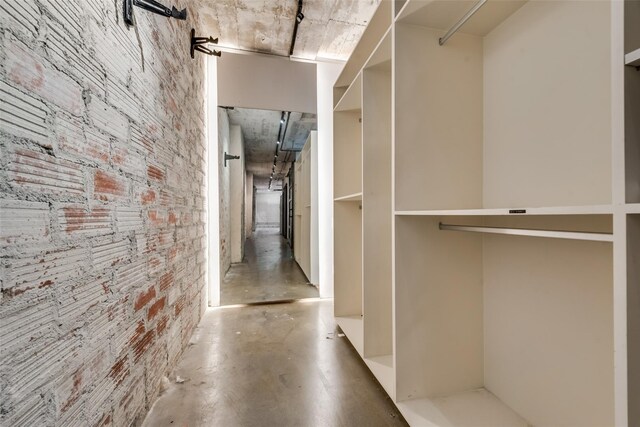 1122 Jackson St Unit 420, Dallas, TX 75202 - hall featuring concrete floors and brick wall