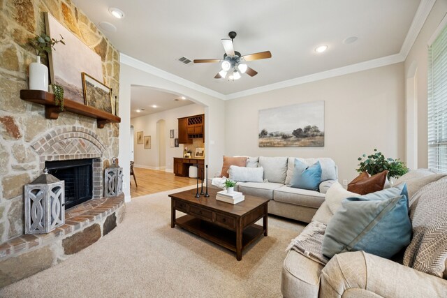 5809 Sterling Trl, Mckinney, TX 75071 - living room with ceiling fan, ornamental molding, arched walkways, a fireplace, and recessed lighting