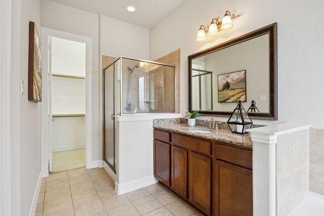 5809 Sterling Trl, Mckinney, TX 75071 - full bathroom with a stall shower, vanity, a spacious closet, and tile patterned flooring
