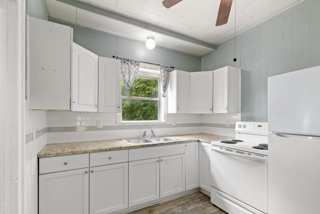 408 W Trinity St, Groesbeck, TX 76642 - kitchen with white appliances, decorative backsplash, white cabinets, and light wood-type flooring
