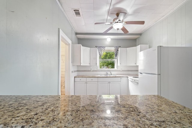 408 W Trinity St, Groesbeck, TX 76642 - kitchen with freestanding refrigerator, dishwashing machine, light stone counters, ceiling fan, and white cabinets