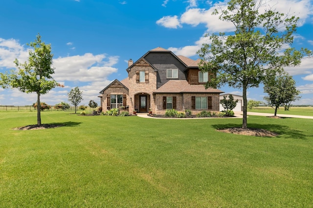 2011 Twin Creeks Cir, Pilot Point, TX 76258 - view of front of house featuring a front yard, a chimney, brick siding, and a shingled roof