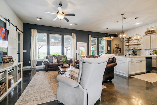 2011 Twin Creeks Cir, Pilot Point, TX 76258 - living room with a ceiling fan, a barn door, concrete flooring, a chandelier, and recessed lighting