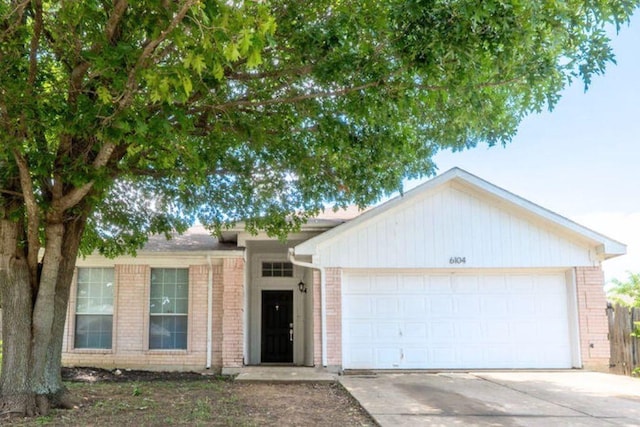 6104 Brookfall Dr, Arlington, TX 76018 - ranch-style house featuring brick siding, concrete driveway, and a garage