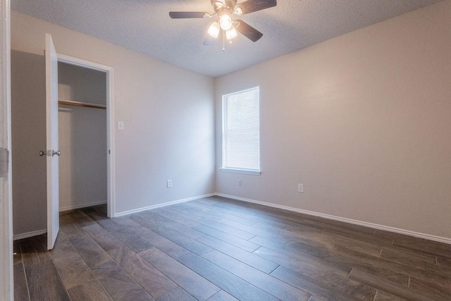 6104 Brookfall Dr, Arlington, TX 76018 - unfurnished bedroom with dark wood-style flooring, a textured ceiling, baseboards, ceiling fan, and a closet