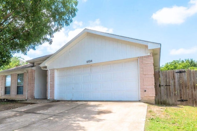 6104 Brookfall Dr, Arlington, TX 76018 - view of front of home with brick siding, driveway, and a garage