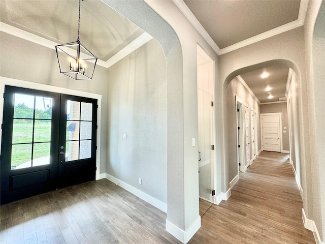 9604 Hester Ln, Argyle, TX 76226 - foyer with french doors, ornamental molding, arched walkways, wood finished floors, and a chandelier