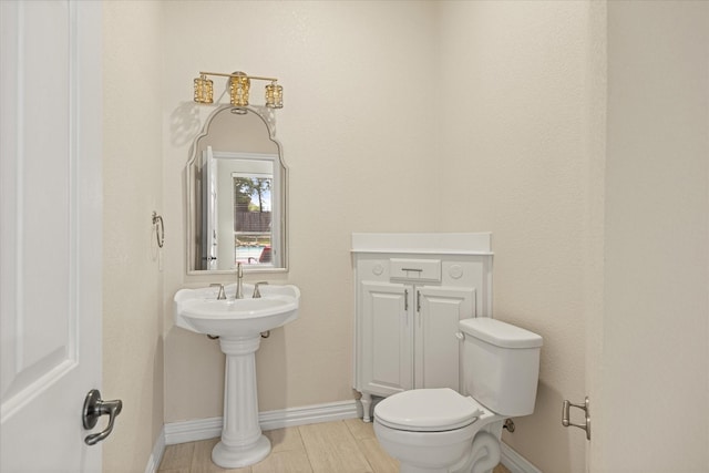 3600 Big Timber Ln, Granbury, TX 76049 - half bathroom featuring baseboards, toilet, and wood finished floors