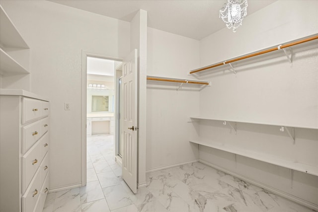 3600 Big Timber Ln, Granbury, TX 76049 - spacious closet featuring light marble finish floors and a chandelier