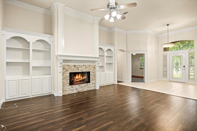 3600 Big Timber Ln, Granbury, TX 76049 - unfurnished living room featuring hardwood / wood-style floors, a ceiling fan, a fireplace, built in features, and ornamental molding