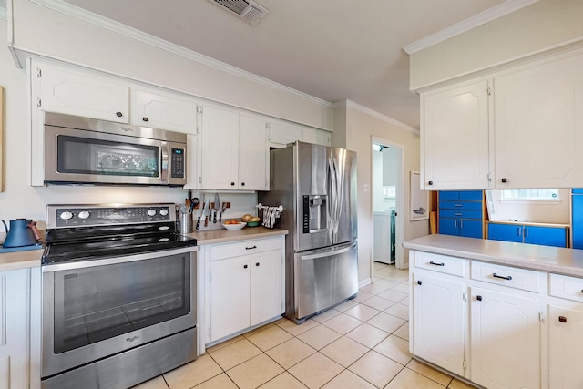 204 Cacti Dr, Lakeside, TX 76108 - kitchen with appliances with stainless steel finishes, white cabinetry, crown molding, light countertops, and light tile patterned floors