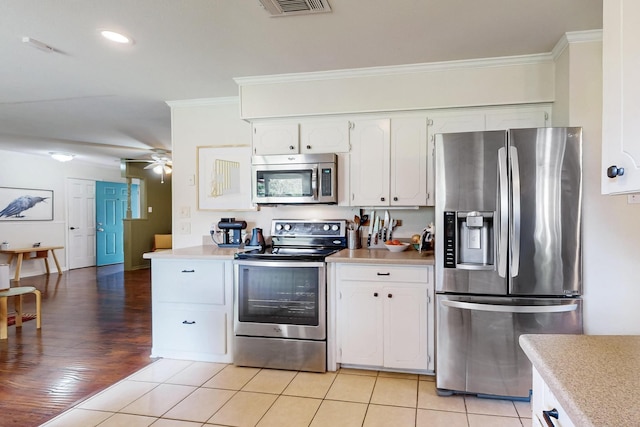 204 Cacti Dr, Lakeside, TX 76108 - kitchen with appliances with stainless steel finishes, crown molding, a ceiling fan, light countertops, and white cabinetry