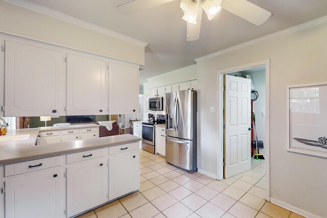 204 Cacti Dr, Lakeside, TX 76108 - kitchen with stainless steel appliances, white cabinetry, ornamental molding, baseboards, and a ceiling fan
