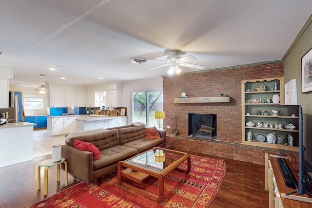 204 Cacti Dr, Lakeside, TX 76108 - living area featuring a ceiling fan, wood finished floors, a fireplace, and ornamental molding