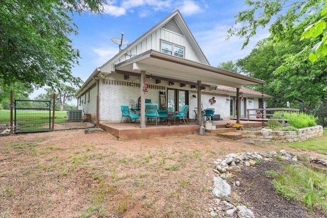 649 Wedgewood, China Spring, TX 76633 - rear view of property featuring board and batten siding, a patio area, a gate, central AC, and brick siding
