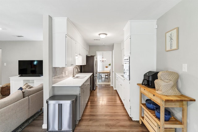 2808 Wren Ave, Fort Worth, TX 76133 - kitchen featuring a sink, open floor plan, light countertops, and wood finished floors
