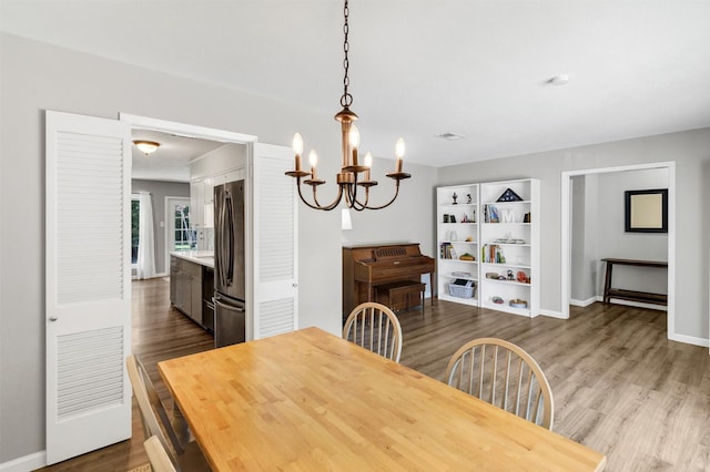 2808 Wren Ave, Fort Worth, TX 76133 - dining space featuring a chandelier, wood finished floors, and baseboards