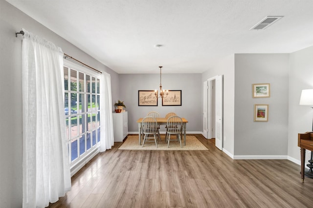 2808 Wren Ave, Fort Worth, TX 76133 - dining room with wood finished floors, a chandelier, and baseboards