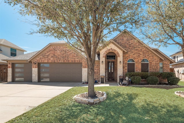 3113 Summer Dr, Little Elm, TX 75068 - view of front of house featuring brick siding, an attached garage, concrete driveway, and a front yard