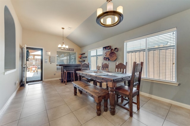 3113 Summer Dr, Little Elm, TX 75068 - dining area featuring a chandelier, vaulted ceiling, light tile patterned floors, and baseboards