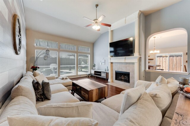 3113 Summer Dr, Little Elm, TX 75068 - living area with a ceiling fan, wood finished floors, a fireplace, arched walkways, and a chandelier
