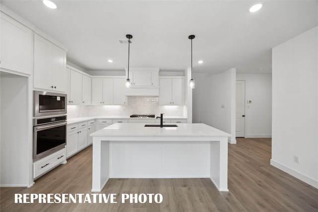 4180 Kestrel St, Prosper, TX 75078 - kitchen featuring stainless steel oven, a sink, built in microwave, tasteful backsplash, and white cabinetry