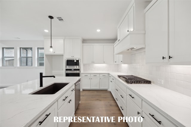 4180 Kestrel St, Prosper, TX 75078 - kitchen with a sink, appliances with stainless steel finishes, white cabinets, recessed lighting, and pendant lighting