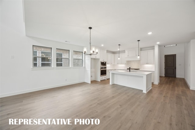 4180 Kestrel St, Prosper, TX 75078 - kitchen featuring stainless steel appliances, white cabinetry, a chandelier, recessed lighting, and baseboards