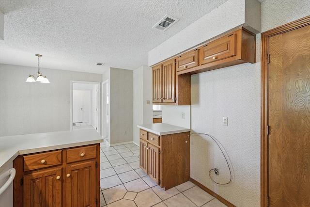 220 Simmons Dr, Coppell, TX 75019 - kitchen with a chandelier, light countertops, brown cabinetry, light tile patterned floors, and wallpapered walls