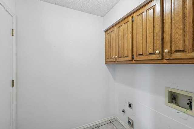 220 Simmons Dr, Coppell, TX 75019 - washroom with cabinet space, electric dryer hookup, washer hookup, light tile patterned flooring, and a textured ceiling