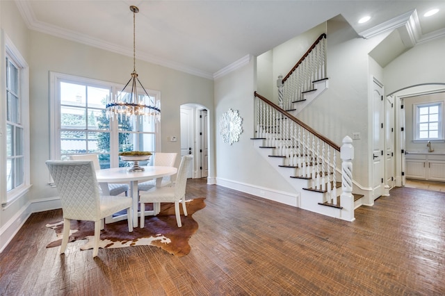 4012 Colgate Ave, University Park, TX 75225 - dining area featuring a chandelier, arched walkways, stairs, crown molding, and baseboards