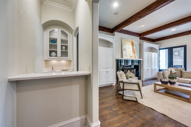 4012 Colgate Ave, University Park, TX 75225 - living area with a high end fireplace, ornamental molding, bar with sink, beam ceiling, and dark wood-style flooring