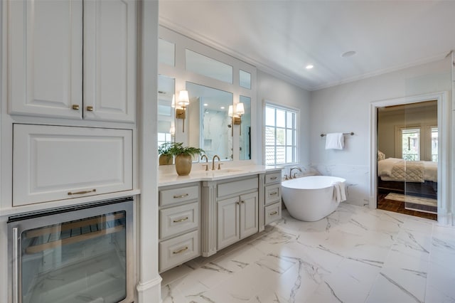 4012 Colgate Ave, University Park, TX 75225 - bathroom featuring ornamental molding, vanity, beverage cooler, a freestanding bath, and connected bathroom