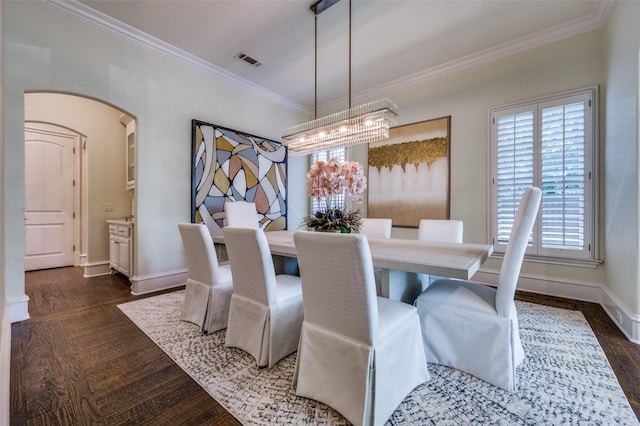 4012 Colgate Ave, University Park, TX 75225 - dining area with a chandelier, ornamental molding, dark wood-type flooring, baseboards, and arched walkways