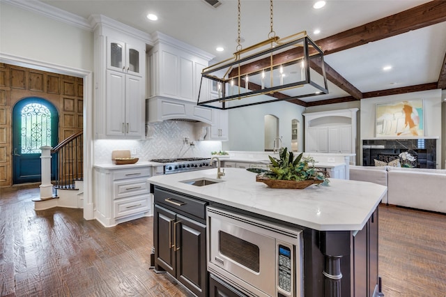 4012 Colgate Ave, University Park, TX 75225 - kitchen featuring stainless steel microwave, open floor plan, white cabinets, decorative backsplash, and recessed lighting