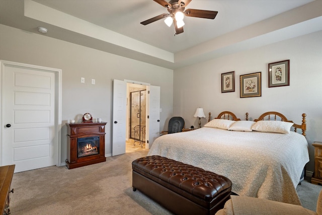 768 Northside Dr, Pilot Point, TX 76258 - carpeted bedroom featuring a glass covered fireplace, ceiling fan, and ensuite bathroom
