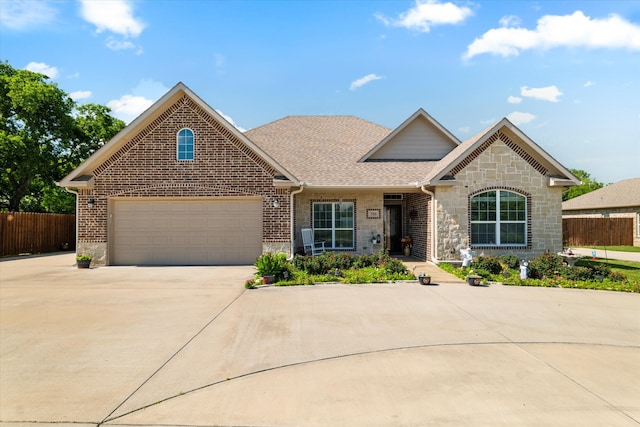 768 Northside Dr, Pilot Point, TX 76258 - view of front of property with driveway, brick siding, a shingled roof, and stone siding