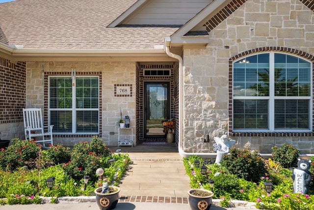 768 Northside Dr, Pilot Point, TX 76258 - view of exterior entry with roof with shingles and stone siding
