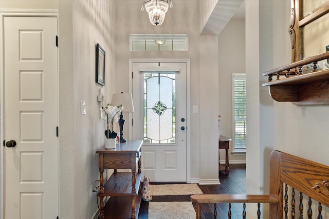 768 Northside Dr, Pilot Point, TX 76258 - entrance foyer with wood finished floors, plenty of natural light, a chandelier, and baseboards