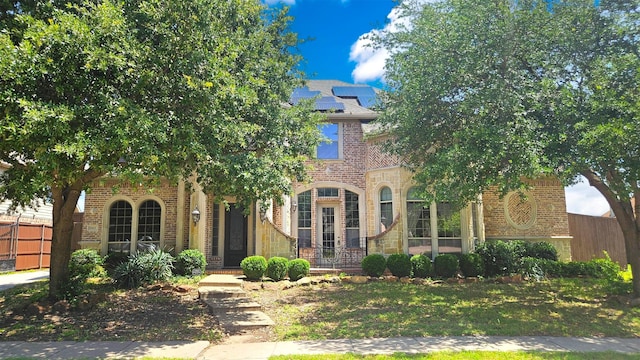 6944 Bridgemarker Dr, Grand Prairie, TX 75054 - view of front of home featuring brick siding and roof mounted solar panels