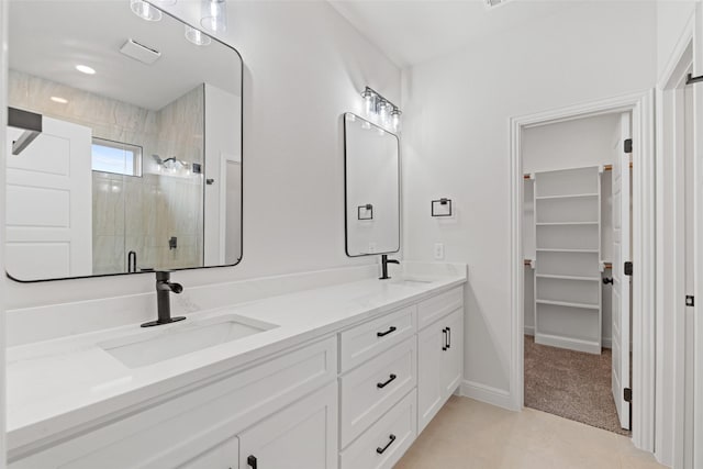 5627 Barkridge Dr, Granbury, TX 76048 - full bathroom featuring double vanity, a tile shower, baseboards, and a spacious closet