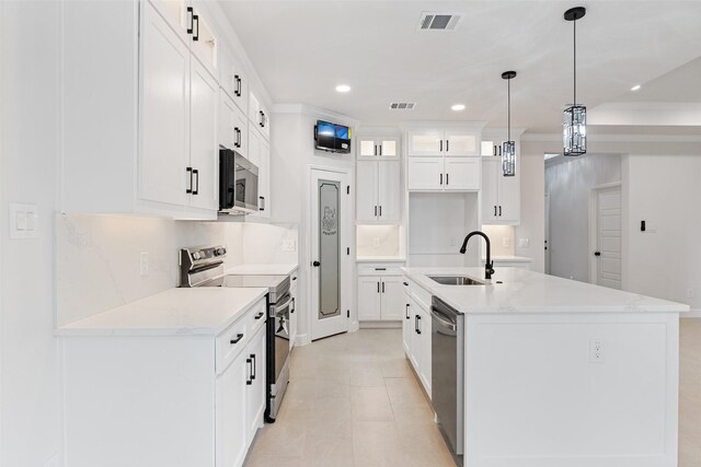 5627 Barkridge Dr, Granbury, TX 76048 - kitchen featuring stainless steel appliances, a sink, a kitchen island with sink, recessed lighting, and white cabinets