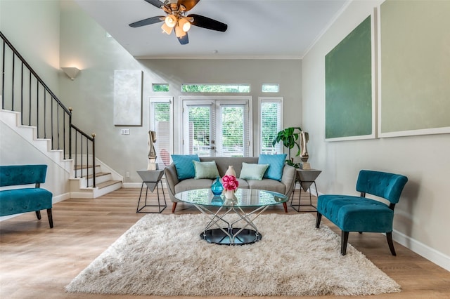 4040 Avondale Ave Unit 201, Dallas, TX 75219 - living room featuring stairway, wood finished floors, baseboards, crown molding, and a ceiling fan