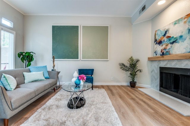 4040 Avondale Ave Unit 201, Dallas, TX 75219 - living area featuring wood finished floors, ornamental molding, a premium fireplace, and baseboards