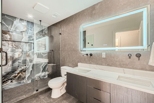 16212 Spring Creek Rd, Dallas, TX 75248 - bathroom featuring tile walls, toilet, a stall shower, double vanity, and tile patterned floors