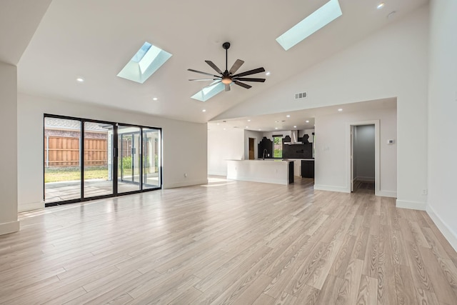 16212 Spring Creek Rd, Dallas, TX 75248 - unfurnished living room with a skylight, high vaulted ceiling, light wood finished floors, and recessed lighting